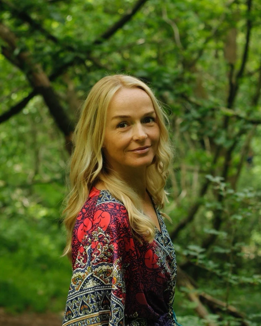 Charlotte Himsworth smiling among green woodland